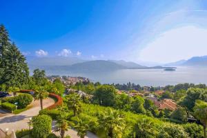 a view of a town with palm trees and a lake at Villa Anna Isole Borromee in Baveno