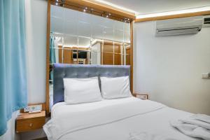 イスタンブールにあるViva Butik Sirkeci Apartのベッドルーム(白いベッド、青いヘッドボード付)
