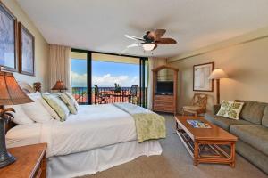 a bedroom with a large bed and a couch at Kaanapali Shores 836 · KS 836 Spacious Studio Kaanapali Oceanfro in Kahana +60 photos