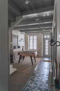 a room with a pool table in the middle of it at L'Olivier de Milou in Le Bois-Plage-en-Ré