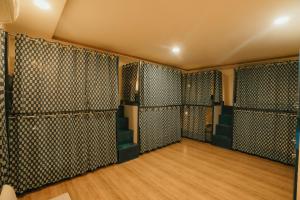 a dressing room with black walls and wooden floors at Jai Kutir Homestay - Hawa Mahal View in Jaipur