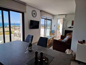 a living room with a table and a clock on the wall at Costa del Sol with proximity to the sea and golf in Sitio de Calahonda