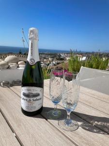 a bottle of wine and two glasses on a table at Costa del Sol with proximity to the sea and golf in Sitio de Calahonda