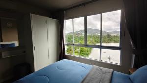 a bedroom with a large window with a view of a river at D Condo mine Kathu in Kathu
