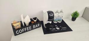 a coffee bar with two bottles of water on a table at b&b il gioiello in Reggio Calabria +7 photos