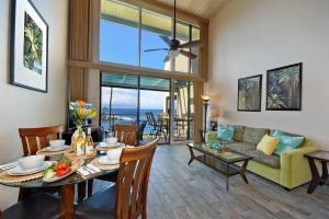 a living room with a table and a couch at Napili Point C21 · NP C21 OceanFront 2BD Condo w AC Ocean Views in Kahana
