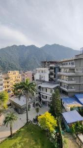 an aerial view of a city with palm trees and buildings at Hotel Yoga Stay Rishikesh in Rishīkesh