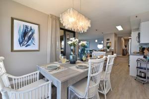 a dining room and kitchen with a table and chairs at Kaanapali Alii 385 · ALII 385 Corner 2BD OceanFront Dream Vacati in Kaanapali