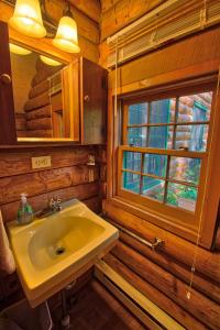 a bathroom with a sink and a window at Winds Aloft in Newland