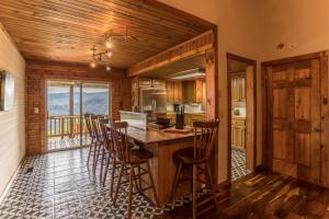 a kitchen with a wooden table and chairs in a room at Grandview Getaway in Boone