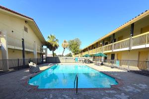 a swimming pool in the courtyard of a hotel at Townhouse Garden Inn & Suites San Antonio I 35 in San Antonio