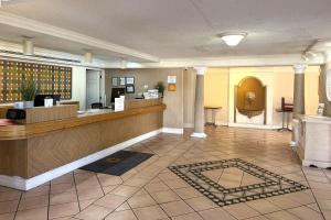 a lobby of a hotel with a reception desk and a lobby at Townhouse Garden Inn & Suites San Antonio I 35 in San Antonio