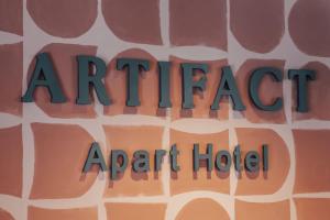 a sign that reads artifact agent hotel on a wall at Artifact Apart Hotel in Tbilisi City