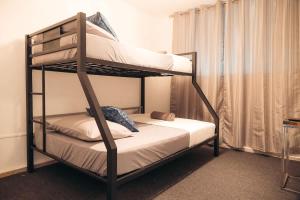 a bedroom with two bunk beds in a room at Cayenne Cozy Apt with Generator and Cistern in Bayamon in Sierra Linda +10 photos