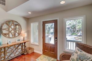 a living room with a wooden door and a window at Fairway Oasis in Hilton Head Island