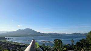 a view of a large body of water with a mountain at Adelisca Glamping, Cafe and Villa in Kubupenlokan +17 photos