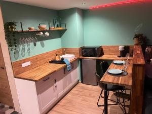 a kitchen with a counter and a table in it at bulles et détente in Seuil