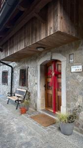 a house with a door with a red bow on it at 4 Elements Glamping & Apartments in Bled