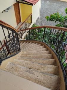 a staircase with a wrought iron railing at Hotel Mirador in La Joya de los Sachas