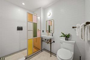 a bathroom with a toilet and a sink at Freeman 303 by Rove - 1BR Condo with Shared Amenities in New York