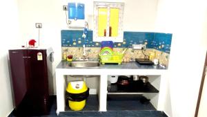 a toy kitchen with a sink and a refrigerator at SERENITY BAY HOME 2bhk in Pondicherry