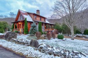 a log home with snow on the ground at Rivers Edge at Eagles Nest in Banner Elk