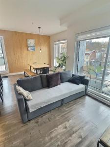 a living room with a couch and a table at Chez Temporel - Condo urbain in Quebec City