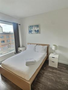 a bedroom with a large bed and a window at Chez Temporel - Condo urbain in Quebec City