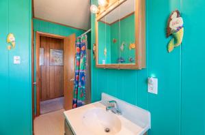 a bathroom with a sink and a mirror at Sun Byrne - K1060 in Whalebone +43 photos