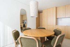 Un comedor con una mesa y sillas y un espejo. en GuestReady - DPV GuestHouse - Apart 6, en Oporto
