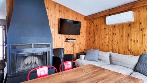 a living room with a couch and a fireplace at Winter at Wildwood in Bailieboro