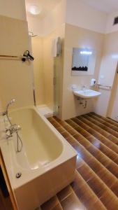 a bathroom with a bath tub and a sink at Casa Vacanza Biasi in Pergine Valsugana +18 photos