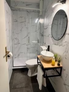 a bathroom with a toilet and a sink and a shower at Apartment No 3 in Fulda