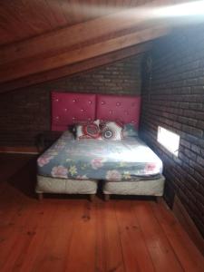 a small bedroom with a bed in a attic at la reyna in Monte Grande