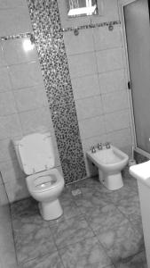 a bathroom with a toilet and a sink at la reyna in Monte Grande