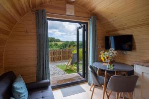 a small room with a table and a sliding glass door at Polgooth Inn in St Austell