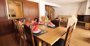 a dining room with a table and chairs with red napkins at Gorgeous Home Saser in Santa Cristina in Val Gardena