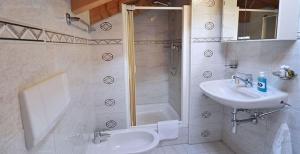 a bathroom with a sink and a shower at Gorgeous Home Saser in Santa Cristina in Val Gardena