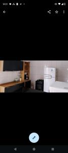 a picture of a kitchen with a white refrigerator at Casa Cop 30 Belém in Belém