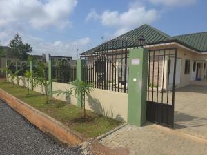 a building with a gate on the side of a street at Lakeside Hilltop Haven -3 Bedroom House in Katamanso