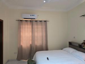 a bedroom with a white bed and aperature at Lakeside Hilltop Haven -3 Bedroom House in Katamanso