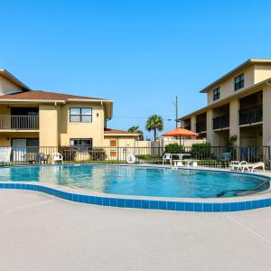 a swimming pool in front of a apartment complex at Welcome to Oasis #21 Your Coastal Retreat in Daytona Beach Shores-Walk To The Beach in Daytona Beach Shores