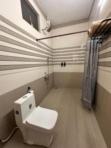 a bathroom with a toilet and a shower at 4elementis beach homestay in Mararikulam +23 photos
