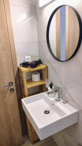 a bathroom with a white sink and a mirror at Kleopatra's residence in Bendevís +17 photos