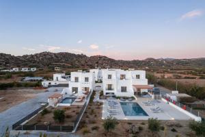an aerial view of a white house with a swimming pool at calmare collection hotel in Plaka