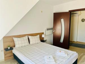 a bedroom with a bed with two towels on it at Cozy apartment Alba with two bedrooms! in Blagoevgrad