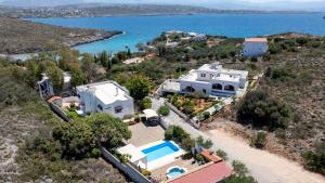 an aerial view of a house and the water at Luxury Seaside Villa Plumeria ,50m to Sandy Beach, Chania in Tersanas