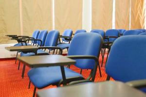 a room with desks and blue chairs in a classroom at Хотел Кипарис, Враца in Vratsa