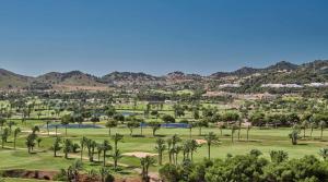 a view of a golf course with palm trees and mountains at La Manga Club, Las Palmeras 12 in Cartagena