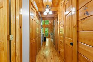 a hallway with wood paneled walls and a ceiling at Hot Tub & WiFi - Birdsong - Red River Gorge KY in Stanton